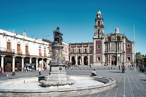 People enjoy Santo Domingo Plaza in Old Town Mexico City, Mexico on a sunny day.