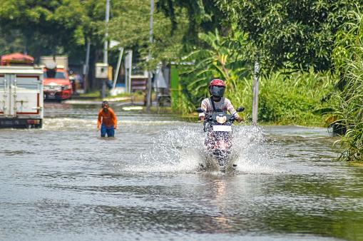 a motorbike that crashed through quite deep floodwaters in Gresik district, Indonesia, 21 February 2024.