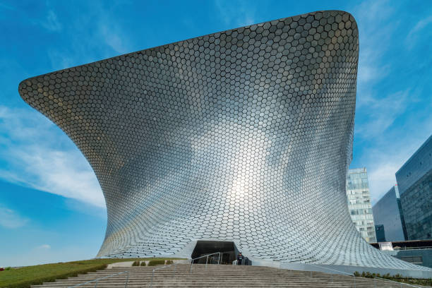 Guard stands in front of Museo Soumaya in the Polanco neighborhood of Mexico City on a sunny day.