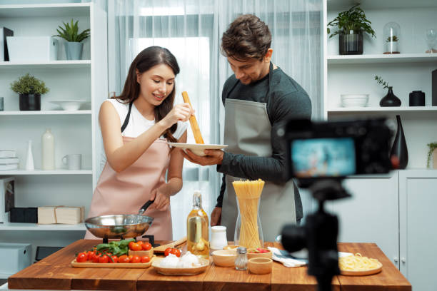 istock Chef influencers cooking special spaghetti with tongs to fried pan. Postulate. 2031716482