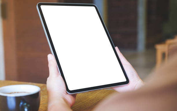 istock Mockup image of a woman holding digital tablet with blank white desktop screen 2031717510