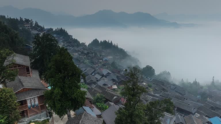 A large Miao village is above the clouds and mist