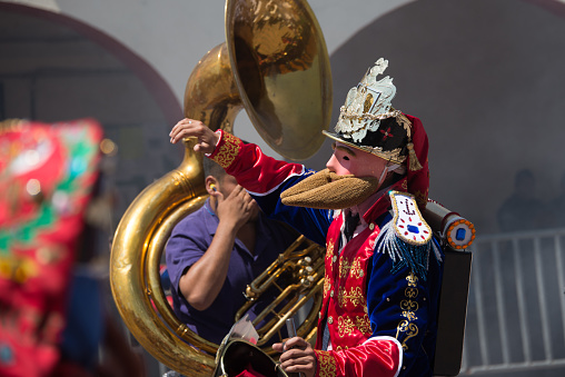 Young people playing saxophone outdoors, conductor in front, marching band in a traditional celebration. Mondoñedo medieval historical reenactment. Lugo province, Galicia, Spain.