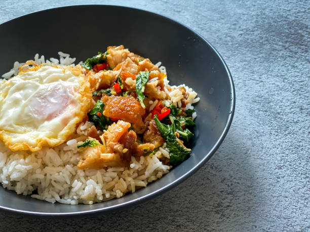 Rice topped with crispy pork belly with Thai basil