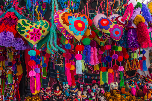 Colorful Mexican handicrafts, meticulously crafted with a burst of colors and top-quality materials by Mexican artisans, displayed at a market.