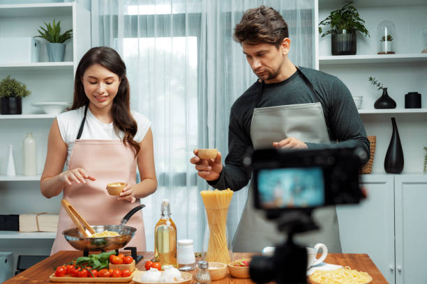 istock Chef influencers cooking special spaghetti with tongs to fried pan. Postulate. 2031803156