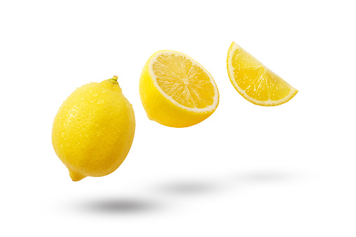 Flying yellow lemon with slices and shadow isolated on white background.
