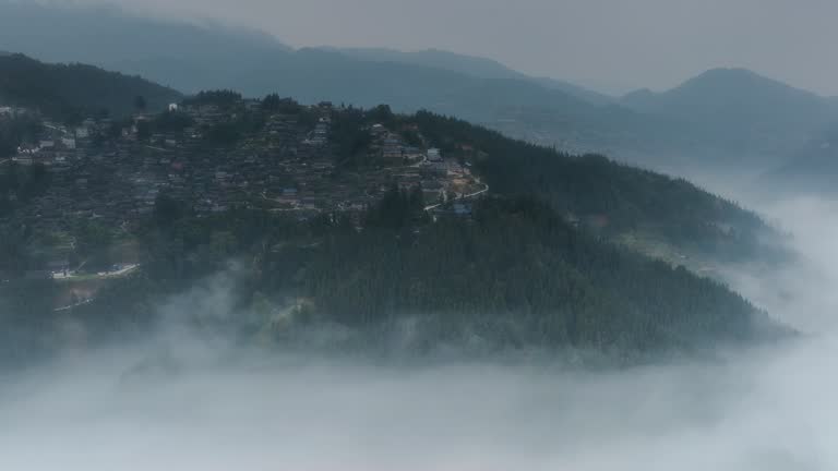 A large Miao village is above the clouds and mist