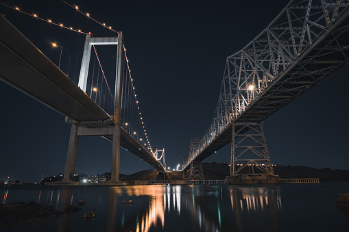 Photograph taken along the coast of California from under the Carqunez bridge at night with a long shutter speed