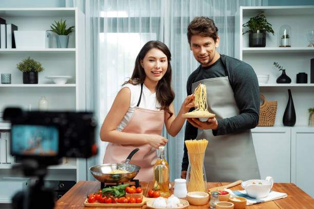 istock Chef influencers cooking special spaghetti with tongs to fried pan. Postulate. 2031865485