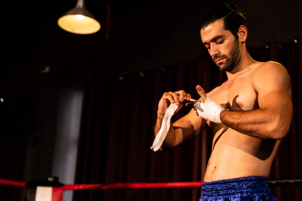istock Caucasian boxer portrait wrapping his hand. Impetus 2031883783