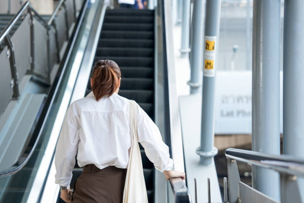 istock Woman using an escalator to walk to the train station to wait. 2031959989