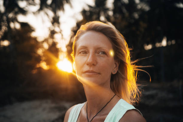 Portrait of a young beautiful woman outdoors Portrait of a young beautiful woman in a tropical settings. happy peaceful woman stock pictures, royalty-free photos & images