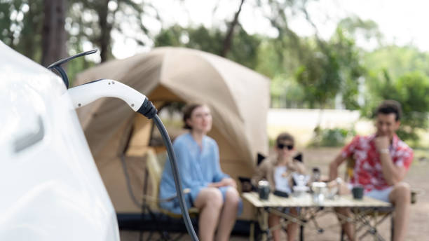 istock Lovely sit on trunk, charging EV car with EV charging station. Perpetual 2031964085