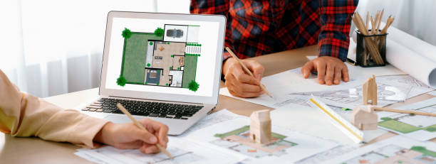 istock Professional architect represented ECO house displayed on laptop. Delineation. 2031970806