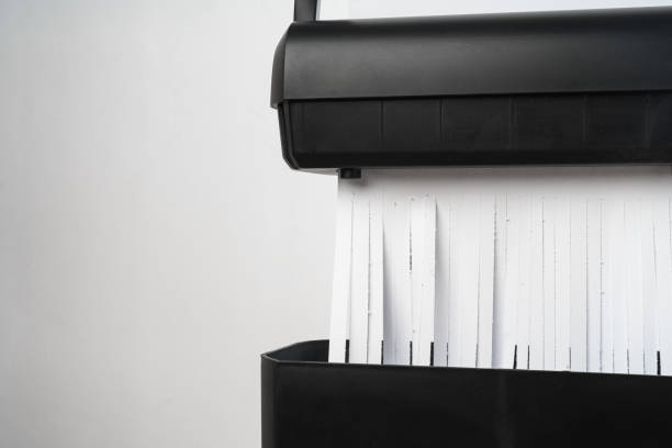 istock Black paper shredder cutting paper on gray background 2031997382