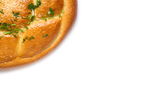 Part of a homemade salty pie on a white background. Top view. Copy space. Fresh natural baked goods close-up.