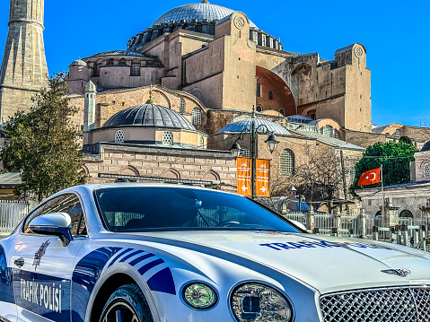 Istanbul, Turkey - February 9, 2024: A Bentley police car parked in front of Hagia Sophia. Hagia Sophia was an Eastern Orthodox church and then a Catholic church until 1453, when it was converted to a mosque by Ottoman Empire.