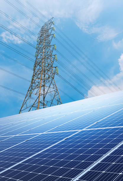 istock Solar panels reflect sparkling light From the sun, and high-voltage electricity transmission pylon in behind. Clean energy and the environment. 3D rendering 2032036994