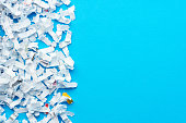 Shredded paper pieces on a blue background