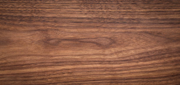 istock Walnut wood texture background. Wide format black walnut natural texture desktop background. 2032043925