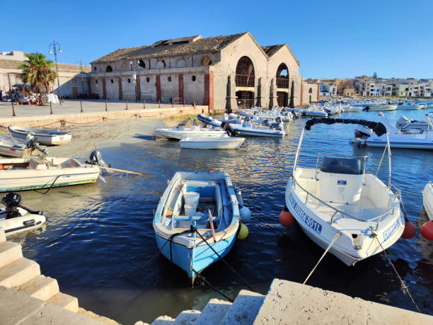 Boats moored at Favignana harbour, Egadi Archipelago, Sicily, Italy.