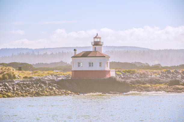 The lighthouse sits alongside the Pacific Ocean. Offering a guiding light to those who travel across the waters of the Pacific. For those on land, it offers a stunning scene. Built in 1896, this lighthouse is located in the Bullards Beach State Park.