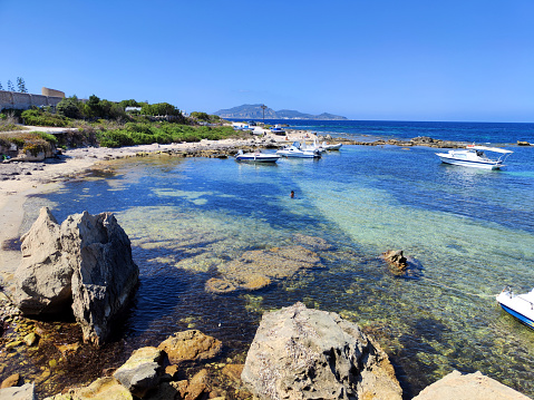 The turquoise waters at Spiaggia di San Nicola, on the island of Favignana in the Egadi Archipelago, Sicily, Italy.