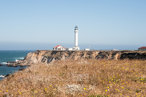 Lighthouse along rocky coast.