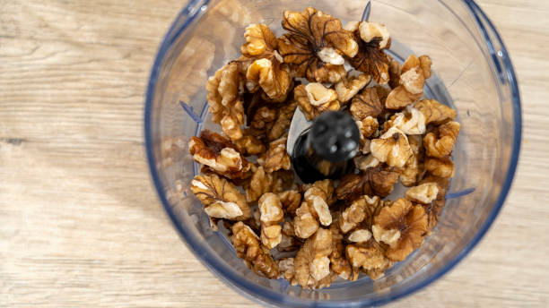 istock Walnut in blender, Grinding walnut kernels in blender, the process of chopping nuts in a blender. 2032098943