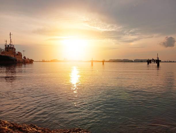 istock Beautiful sunrise over the beach with sun light reflection 2032102632