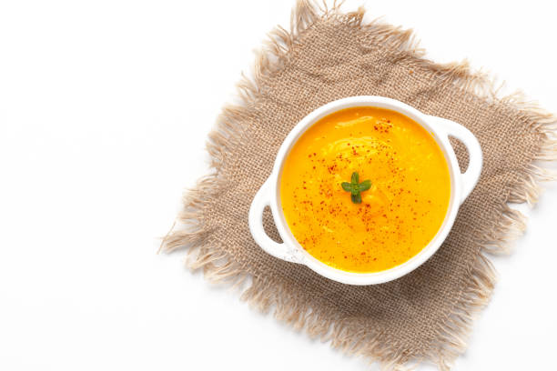 istock Pumpkin soup with croutons on white background, with copy space for text 2032123051