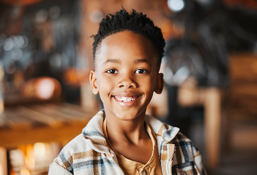 Smile, portrait and little boy in restaurant for weekend lunch with laugh, chill and fun in Africa. Casual, relax and face of happy customer, black child at cafe for morning breakfast with service.