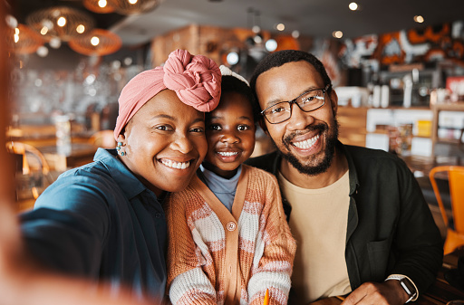 Selfie, parents and portrait of child in restaurant for lunch, dinner and supper together with food. Family, fine dining and mother, father and girl take picture in diner for meal, bonding and relax