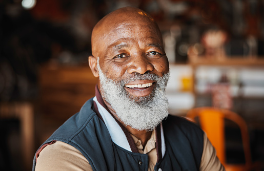 Portrait, manager and mature black man at restaurant chain with smile, confidence and small business owner in cafe. Franchise, entrepreneur and person at store for lunch service with happy face.