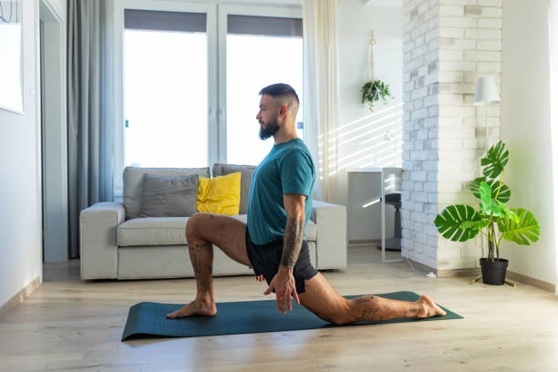 istock Handsome man doing yoga, stretching, resting after home workout, New Year's resolutions, exercising as healthy lifestyle and selfcare. 2032154513