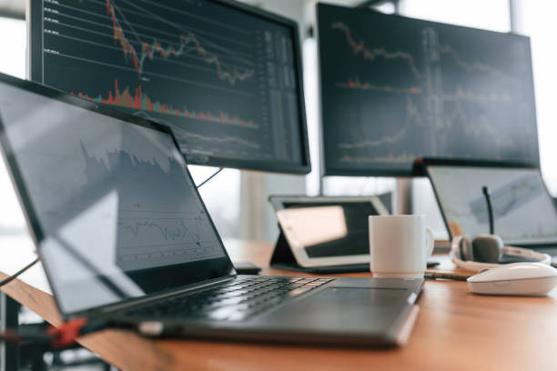 istock Table with laptop and monitors with graphs data in the office 2032160408