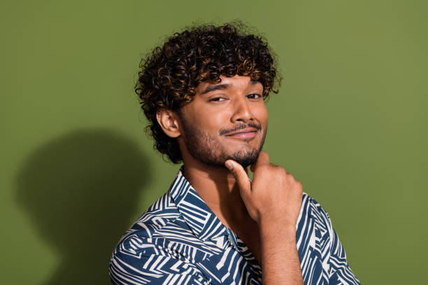 istock Portrait of young confident attractive student man intelligent handsome model posing after barbershop isolated on khaki color background 2032160944