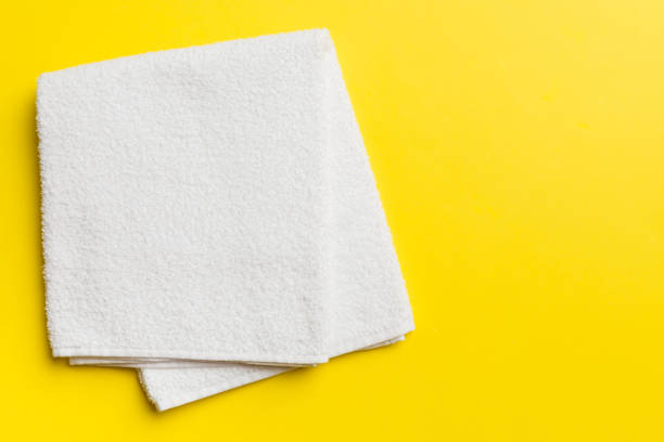 istock Top view of white towels with copy space on colored background 2032184483