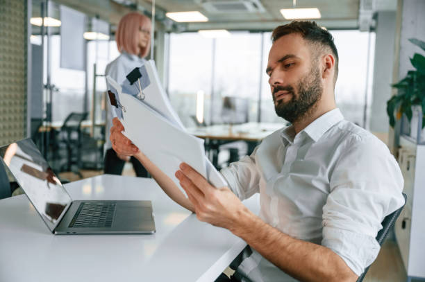 istock With documents. Man and woman are working in the office together 2032191567