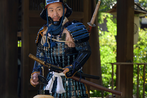 Kyoto, Japan - October 22, 2023: Portrait of a man dressed in historical military costume at Jidai Matsuri (japanese for Festival of the Ages) at the Imperial Palace park