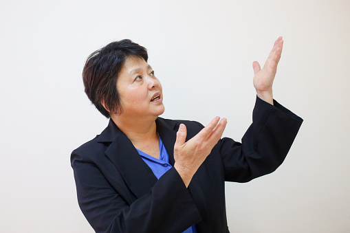 Portrait of an Asian woman hand gesturing