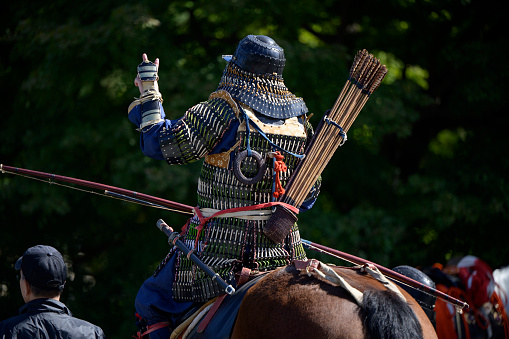 Kyoto, Japan - October 22, 2023: Man dressed in a historical warrior costume sits on a horse at Jidai Matsuri (japanese for Festival of the Ages) at the Imperial Palace park