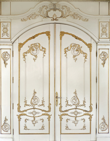 3d illustration. Carved gilded door in Baroque style. Joinery in the interior. Background.