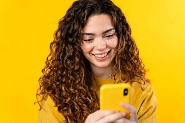 istock Smiling Woman Texting on Phone 2032226910