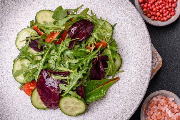 istock Delicious fresh salad with arugula, spinach, cucumber and cherry tomatoes 2032230461