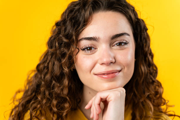 istock Contemplative Woman on Yellow Background 2032231737
