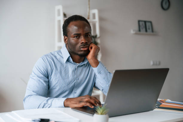 istock Front view. Businessman is working in the office by laptop 2032238174