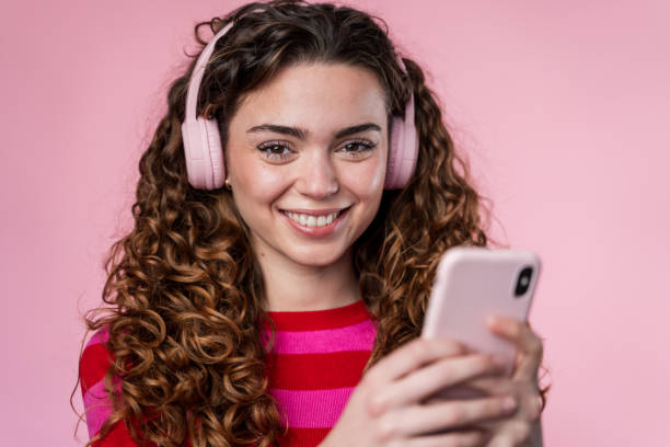 istock Woman Using Smartphone with Headphones 2032238182