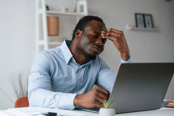 istock Feeling bad, stressful. Businessman is working in the office by laptop 2032238325